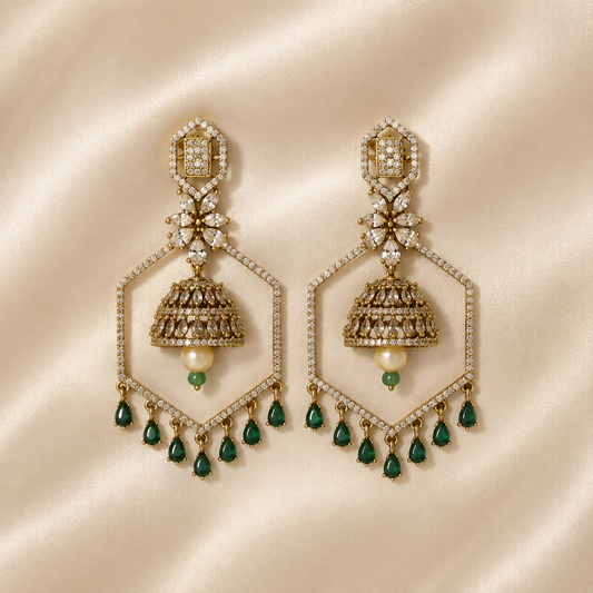 Emerald green geometric jhumka chandelier earrings displayed on satin