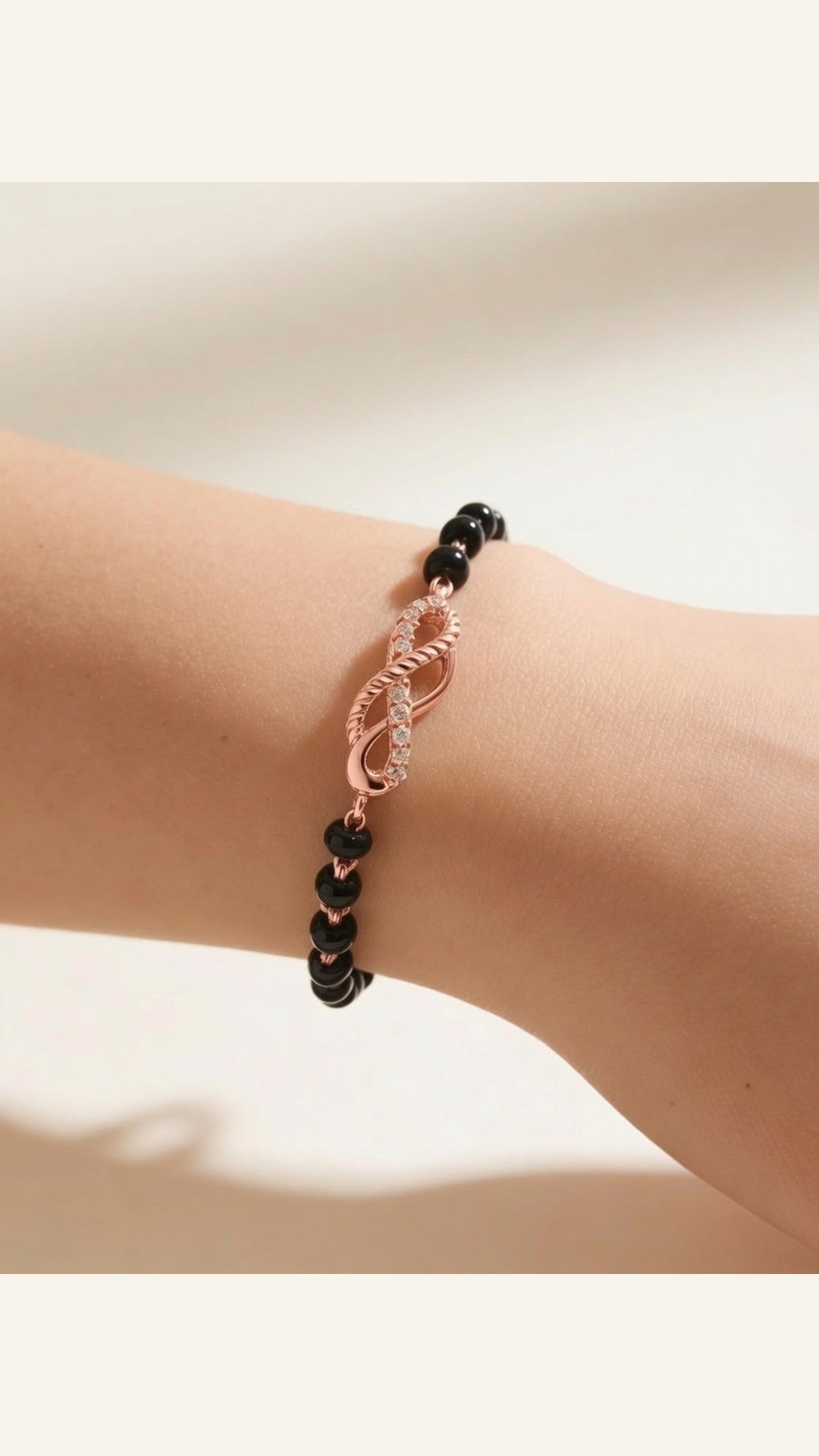 Sterling silver infinity charm bracelet by Belumiee with delicate chain and polished finish, showcasing elegant jewelry design.