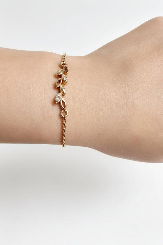 Gold-finish Dainty Leaf Bracelet in 925 sterling silver, shown in a lifestyle view.