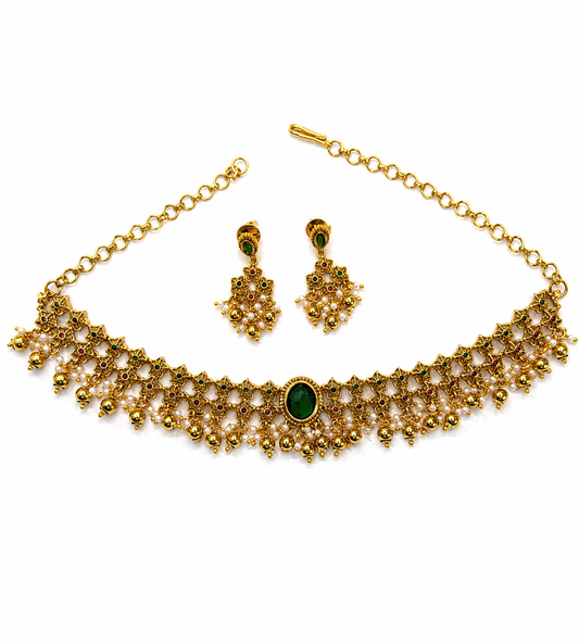 Antique emerald floral pearl choker set with traditional Indian imitation jewelry, featuring intricate designs and elegant craftsmanship.