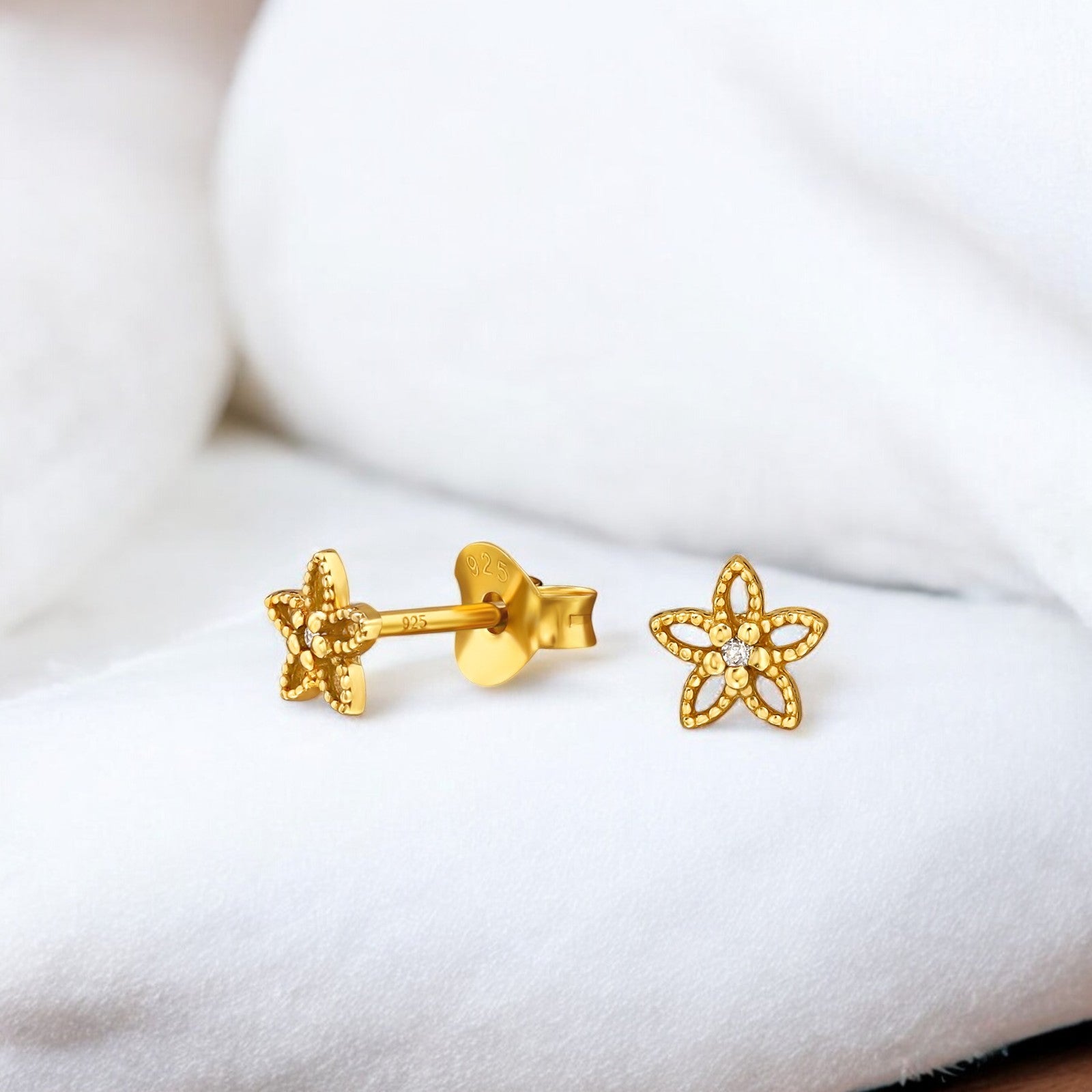 Sterling silver flower ear studs by Belumiee, small floral design perfect for everyday wear, with a shiny polished finish.