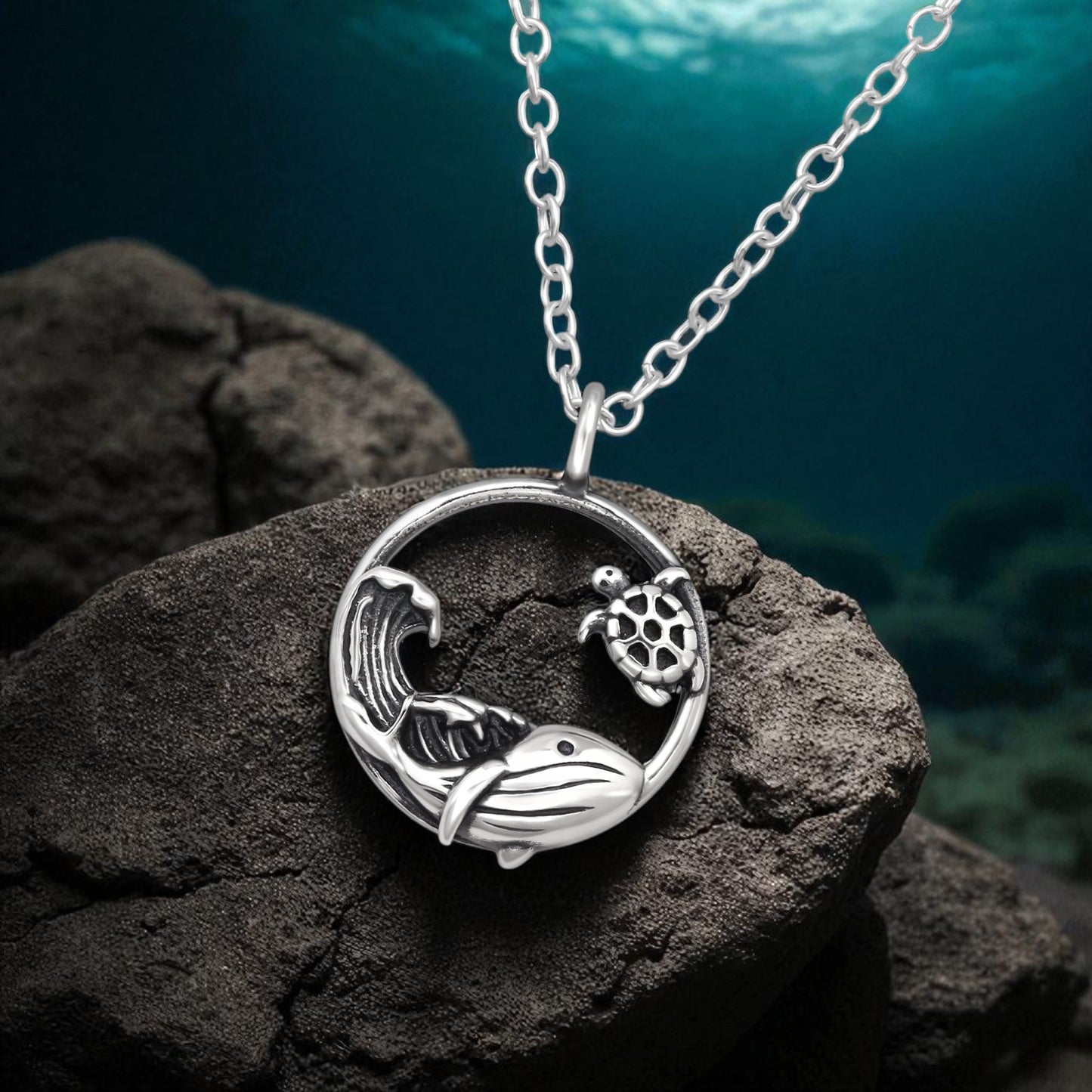 Sterling silver whale, sea turtle, and wave necklace by Belumiee, featuring detailed ocean-inspired designs on a 45cm chain.