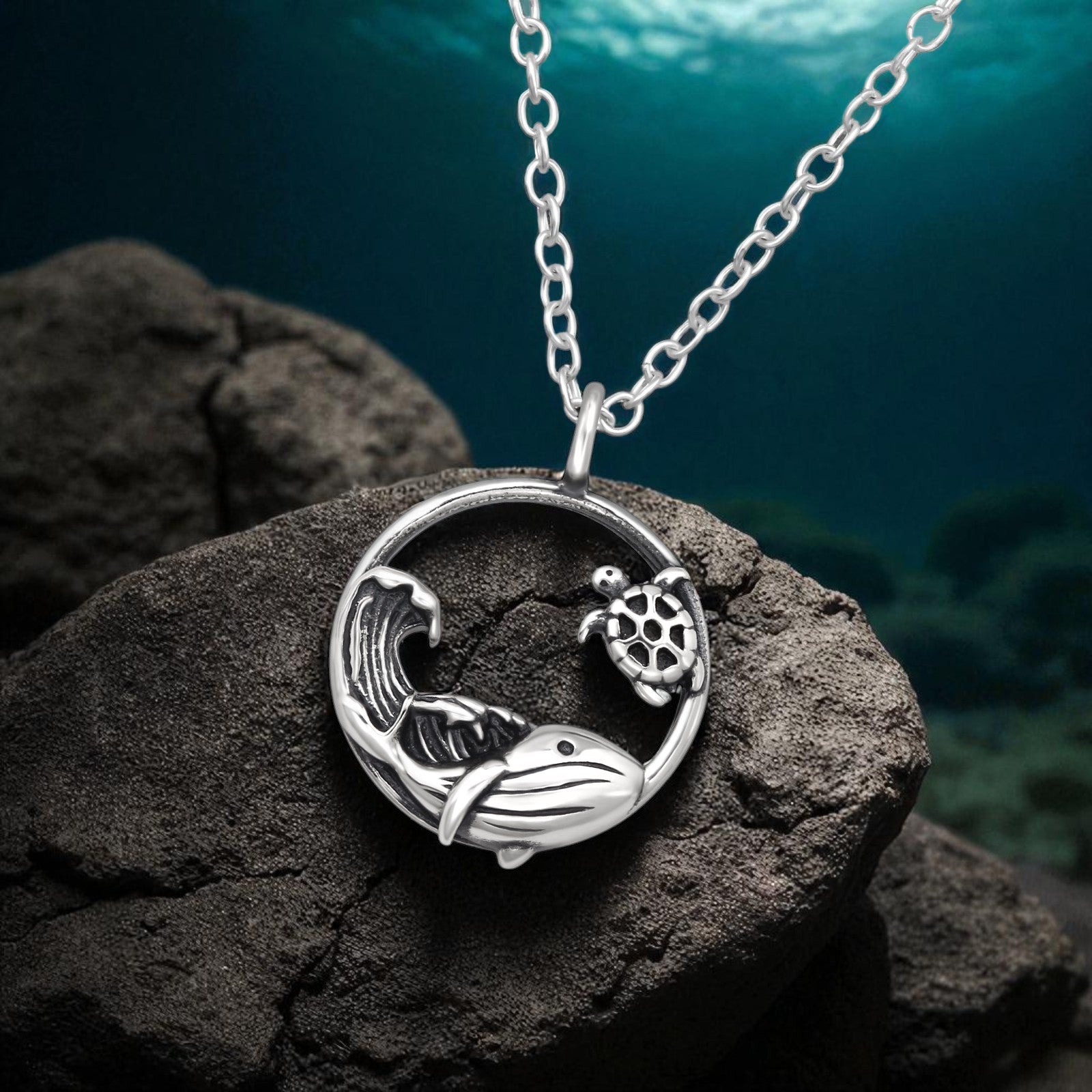 Sterling silver whale, sea turtle, and wave necklace by Belumiee, featuring detailed ocean-inspired designs on a 45cm chain.