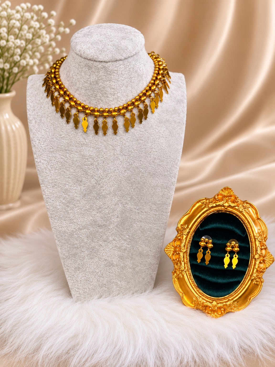 Gold-tone layered leaf drop necklace and earrings set by Belumiee, featuring traditional jewelry design with leaf motifs.