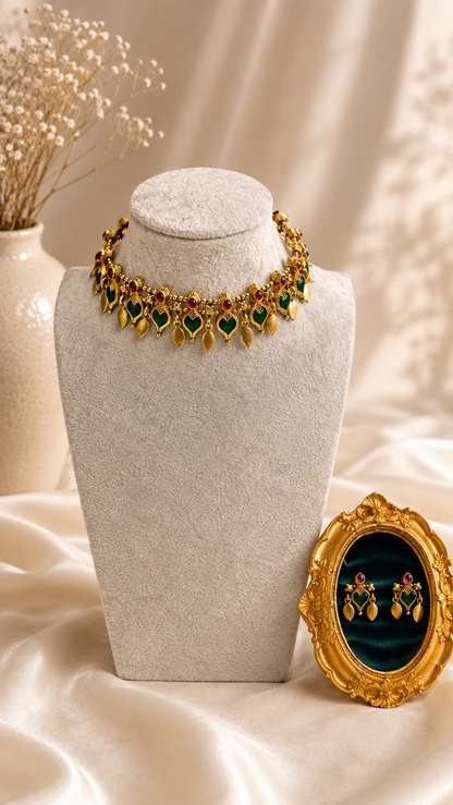 Green and red gold-tone leaf drop necklace and earrings set from Belumiee, featuring traditional jewelry design with leaf motifs.
