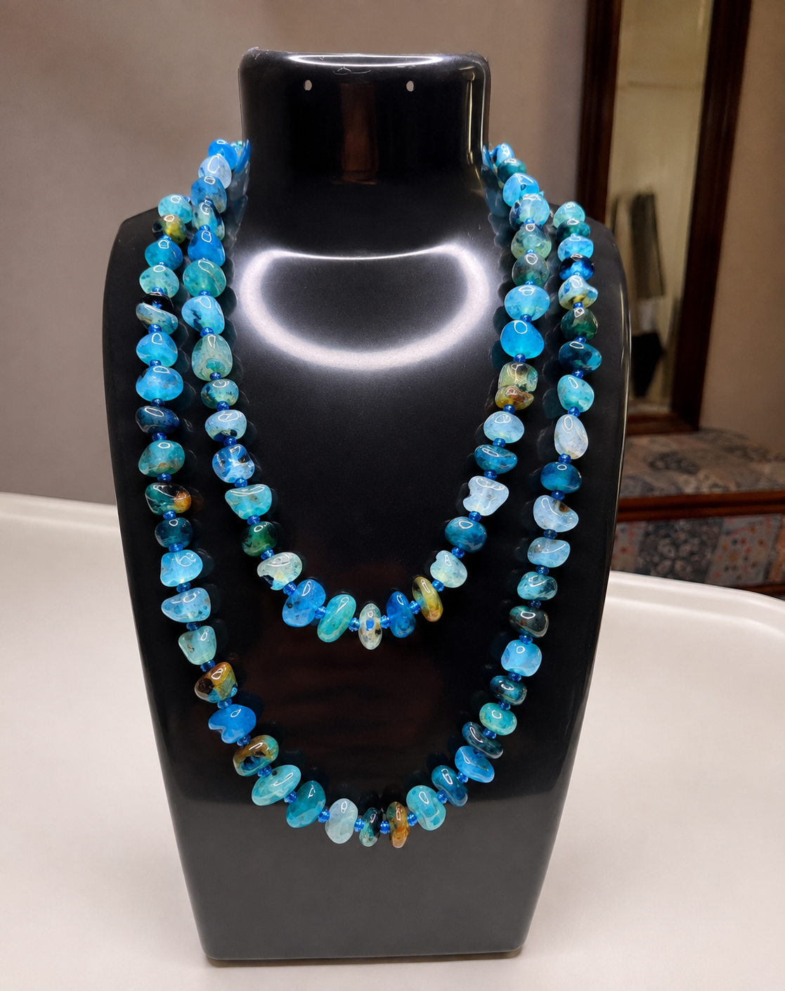 Multi-strand beaded stone necklace by Belumiee, contemporary jewelry featuring colorful stone beads and elegant design.