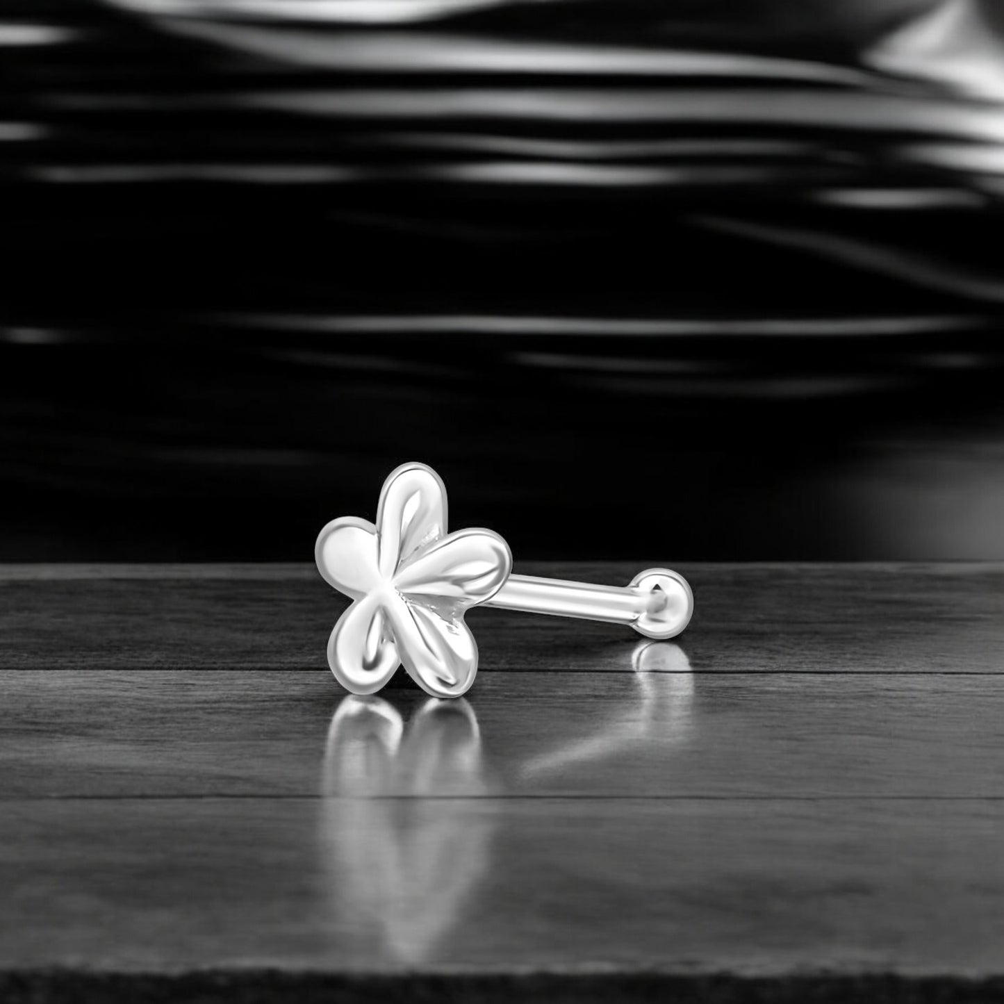 Sterling silver flower nose stud in 22G with a delicate floral design, ideal for nose piercings and fine jewelry.