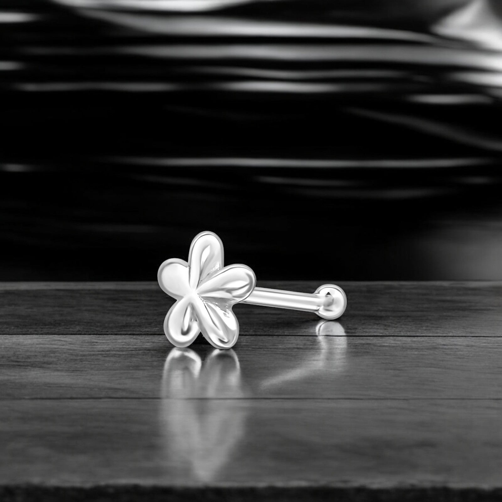 Sterling silver flower nose stud in 22G with a delicate floral design, ideal for nose piercings and fine jewelry.