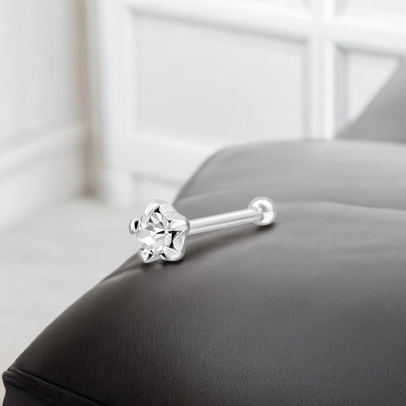 Sterling silver star crystal nose stud in 22G size, Belumiee. Features a sparkling star-shaped crystal on a sleek nose jewelry design.