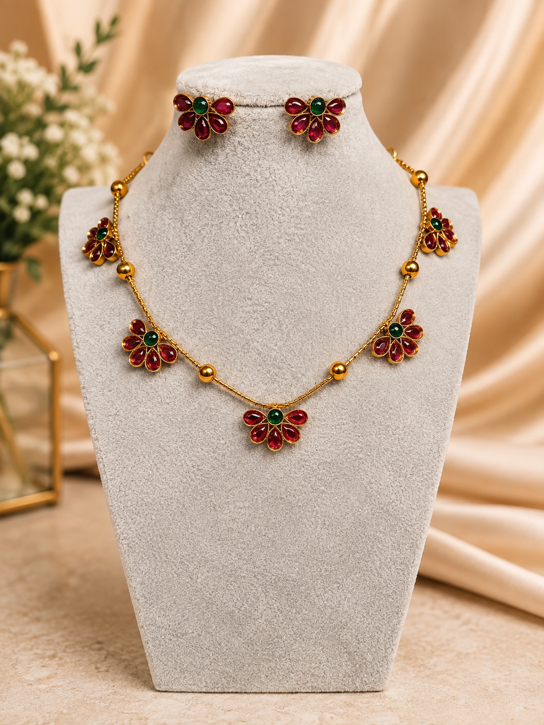 Traditional Ruby Floral Necklace Set by Belumiee with intricate temple design and matching earrings, vibrant red and gold accents.