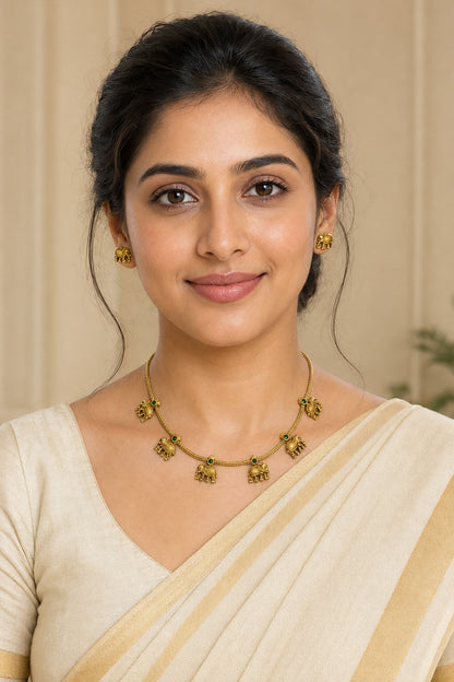 Antique elephant charm necklace and earrings set by Belumiee featuring traditional jewelry with intricate detailing.