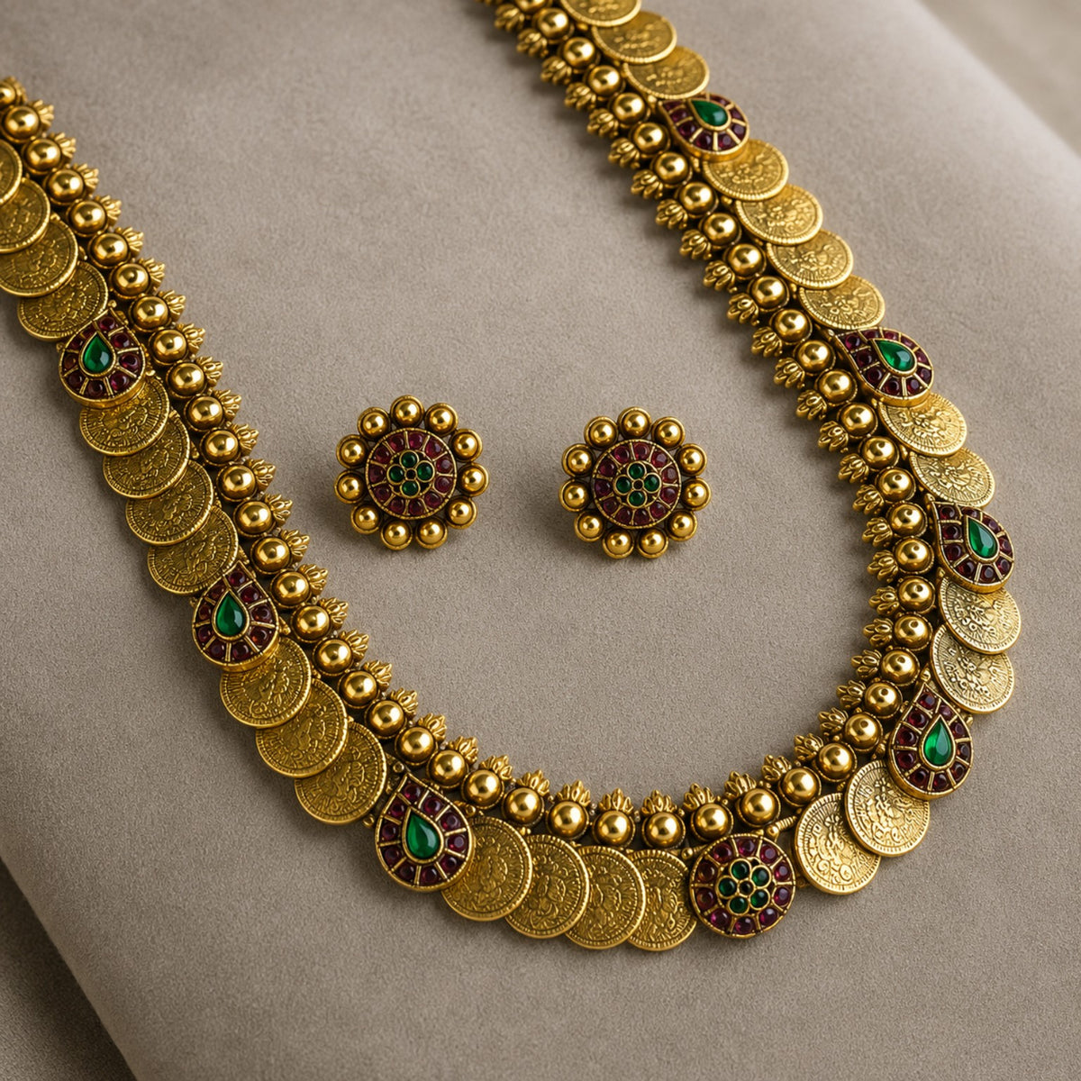Antique gold coin Kasu mala long haram necklace and earrings set with ruby and green accents, traditional Indian jewelry by Belumiee