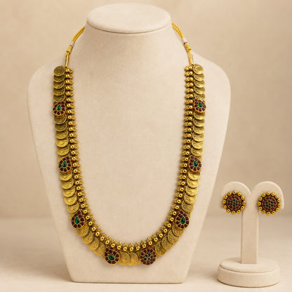 Antique gold coin Kasu Mala long haram necklace and earrings set with ruby and green accents, traditional Indian jewelry by Belumiee.