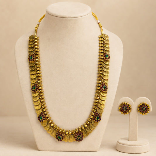 Antique gold coin Kasu Mala long haram necklace and earrings set with ruby and green accents, traditional Indian jewelry by Belumiee.