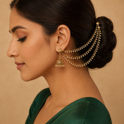 Model wearing one side of an antique gold triple-layer pearl fringe ear chain pair