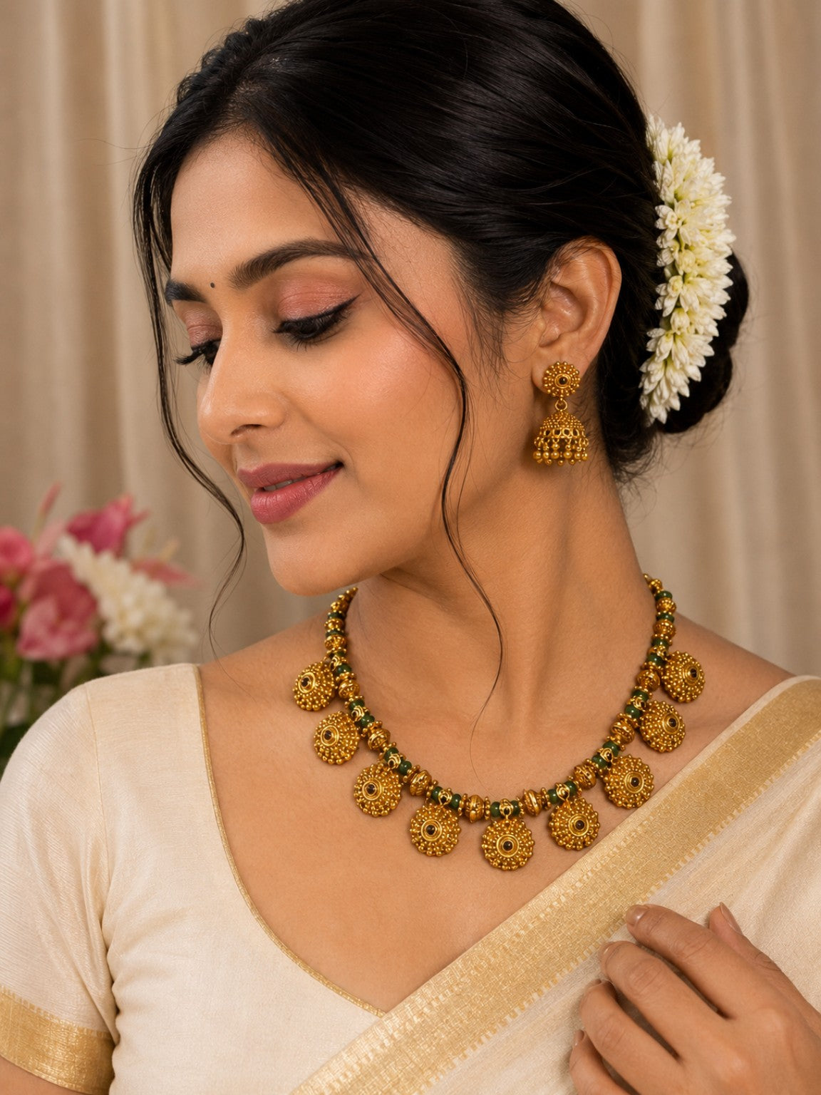 Antique gold and green traditional necklace and jhumka set with intricate design, featuring a statement necklace and matching earrings.