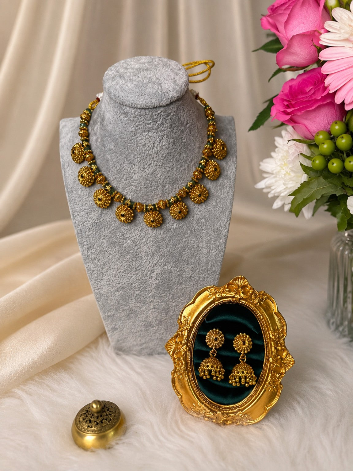 Antique gold and green traditional necklace set with matching jhumkas, featuring intricate design by Belumiee.