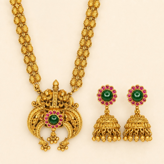 Antique gold temple pendant long necklace and jhumka earrings set with green ruby details, traditional Indian jewelry by Belumiee.