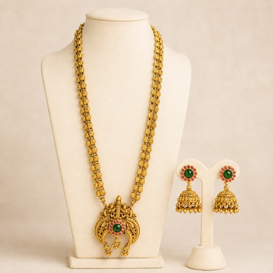 Antique gold temple pendant long necklace and jhumka earrings set with green ruby accents, traditional Indian jewelry by Belumiee.