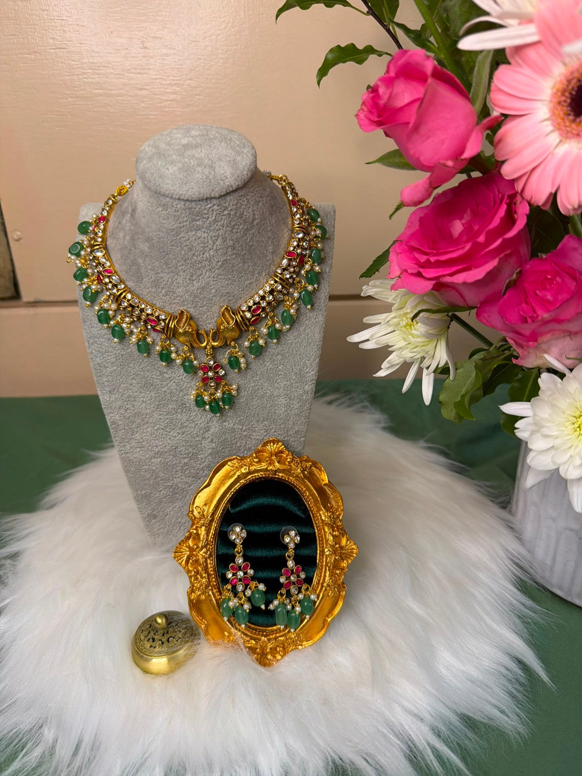 Original photograph of Belumiee antique gold-tone elephant necklace and matching earrings with green bead drops and pink and clear stones.