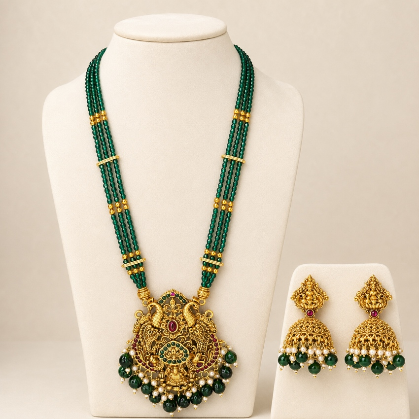 Emerald green beaded temple pendant long haram necklace set with matching jhumka earrings, intricate traditional jewelry by Belumiee.