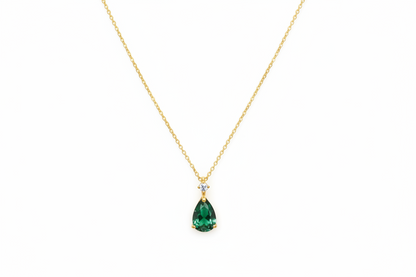 Green teardrop pendant necklace in sterling silver by Belumiee, featuring a sleek, polished design with a vibrant green gemstone.
