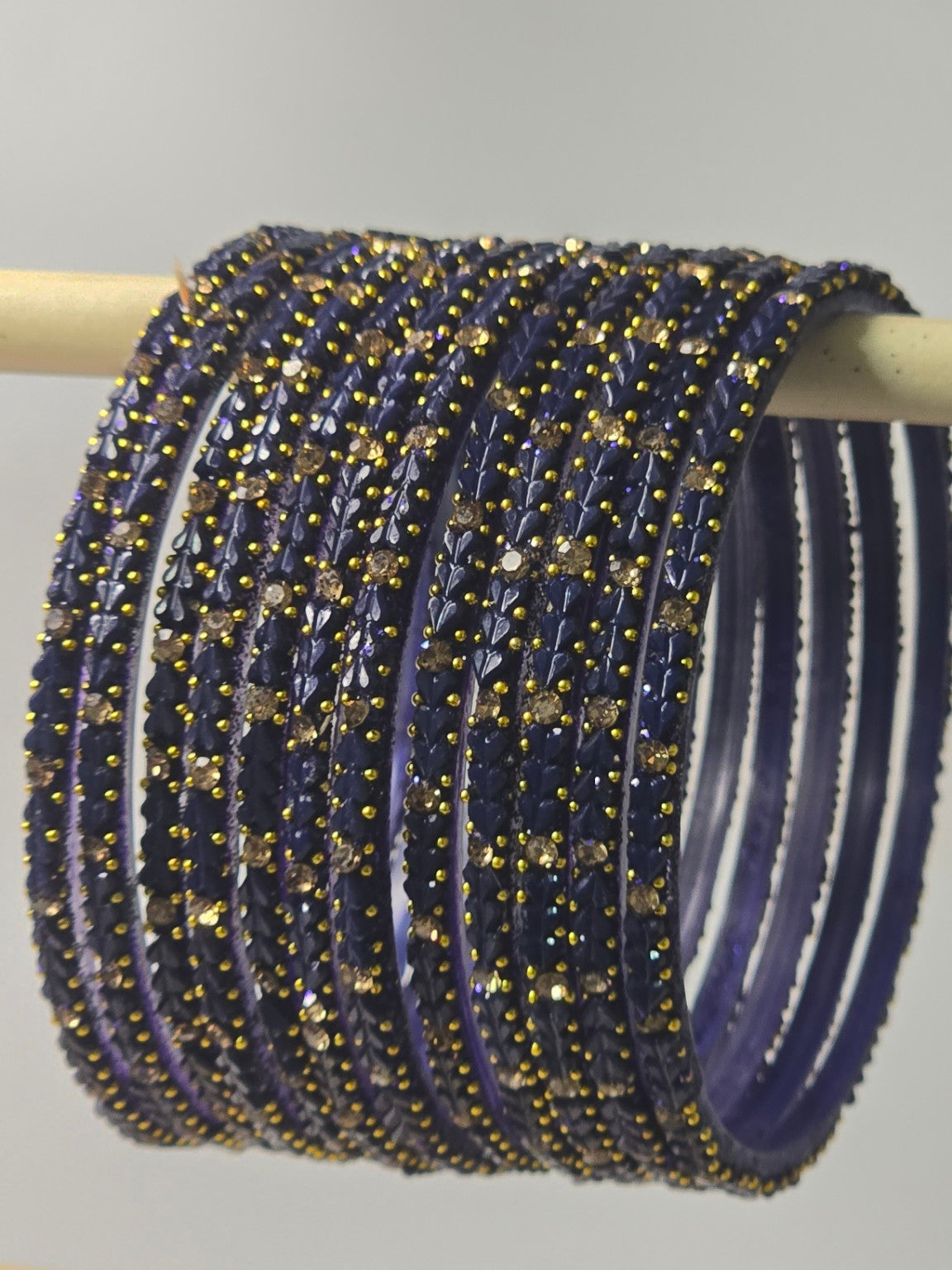 Montana blue-violet Protima glass bangles with raised leaf and stone detailing