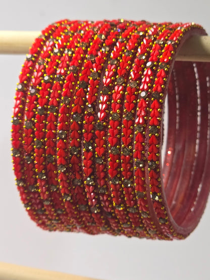 Tomato red Protima glass bangles with raised leaf and stone detailing