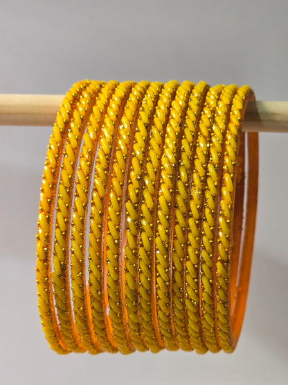 Mango yellow Ratna twisted glass bangles with gold-dot detailing
