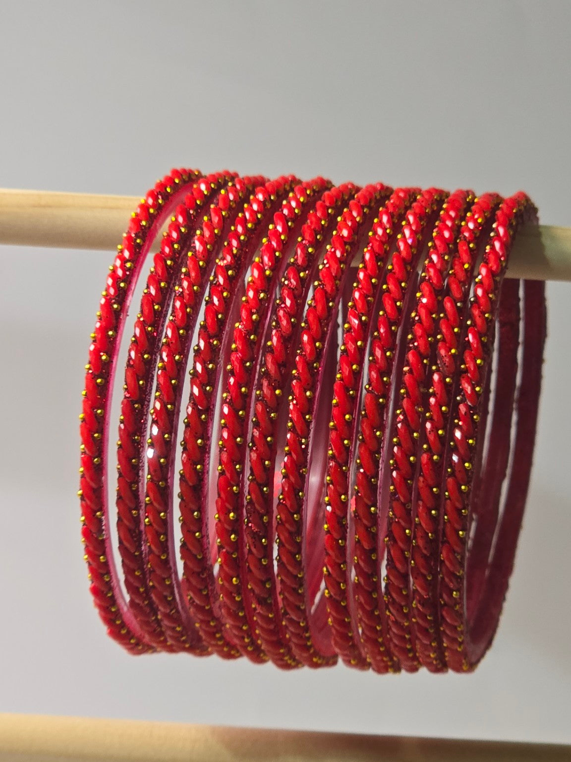 Tomato red Ratna twisted glass bangles with gold-dot detailing
