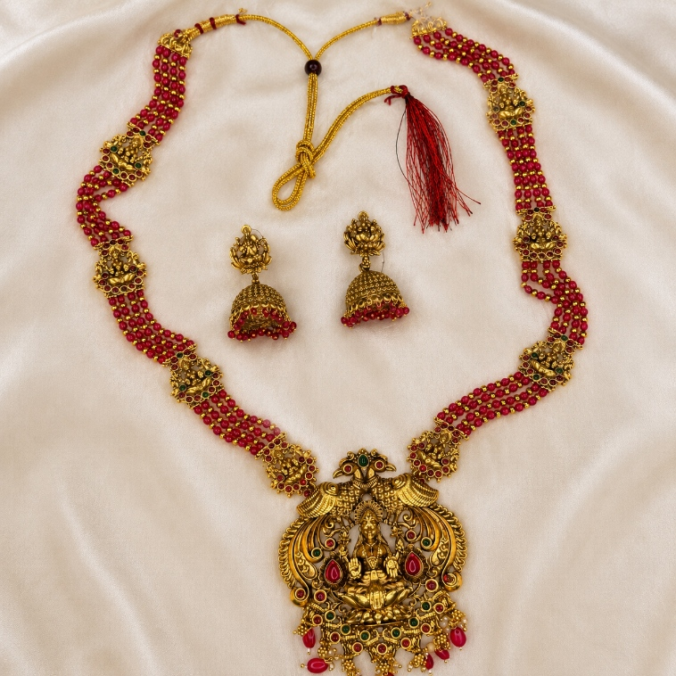 Ruby beaded Lakshmi temple long necklace and jhumka set by Belumiee, featuring intricate traditional jewelry with vibrant red beads.