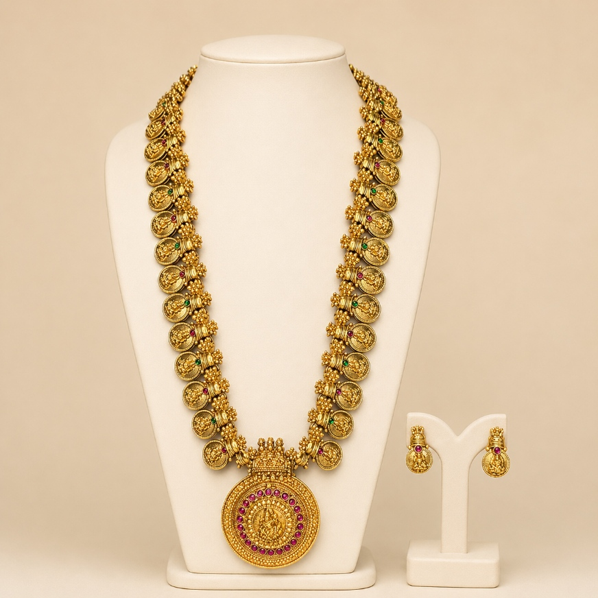 Antique gold temple coin long necklace and earrings set with intricate detailing, traditional jewelry by Belumiee.
