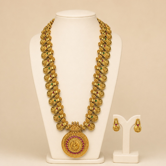 Antique gold temple coin long necklace and earrings set with intricate detailing, traditional jewelry by Belumiee.