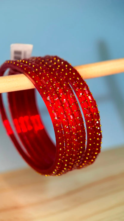 Cherry red Navrang Sparkle Glass Bangles Set by Belumiee, showcasing vibrant, sparkling glass bangles on a neutral background.