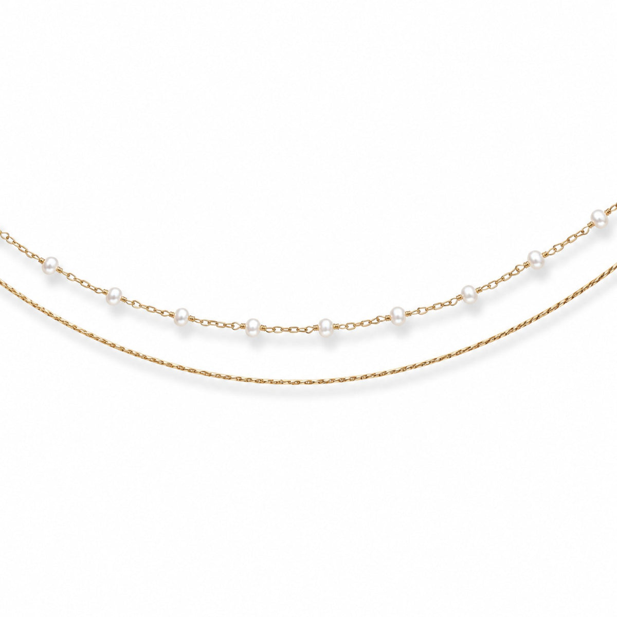 Close-up of double-layer gold-tone hip chain with small evenly spaced white pearls