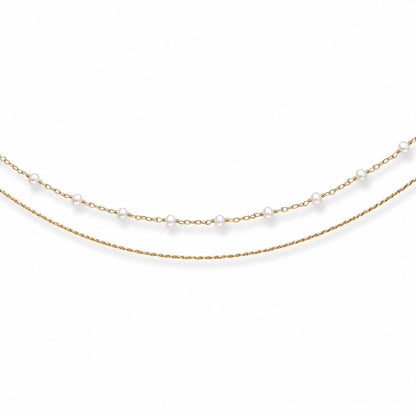 Close-up of double-layer gold-tone hip chain with small evenly spaced white pearls