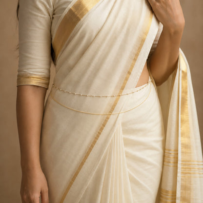 Model wearing delicate pearl double-layer gold-tone hip chain with Kerala saree
