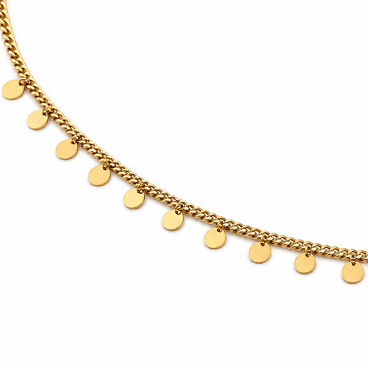 Close-up of gold-tone hip chain with evenly spaced polished round disc charms