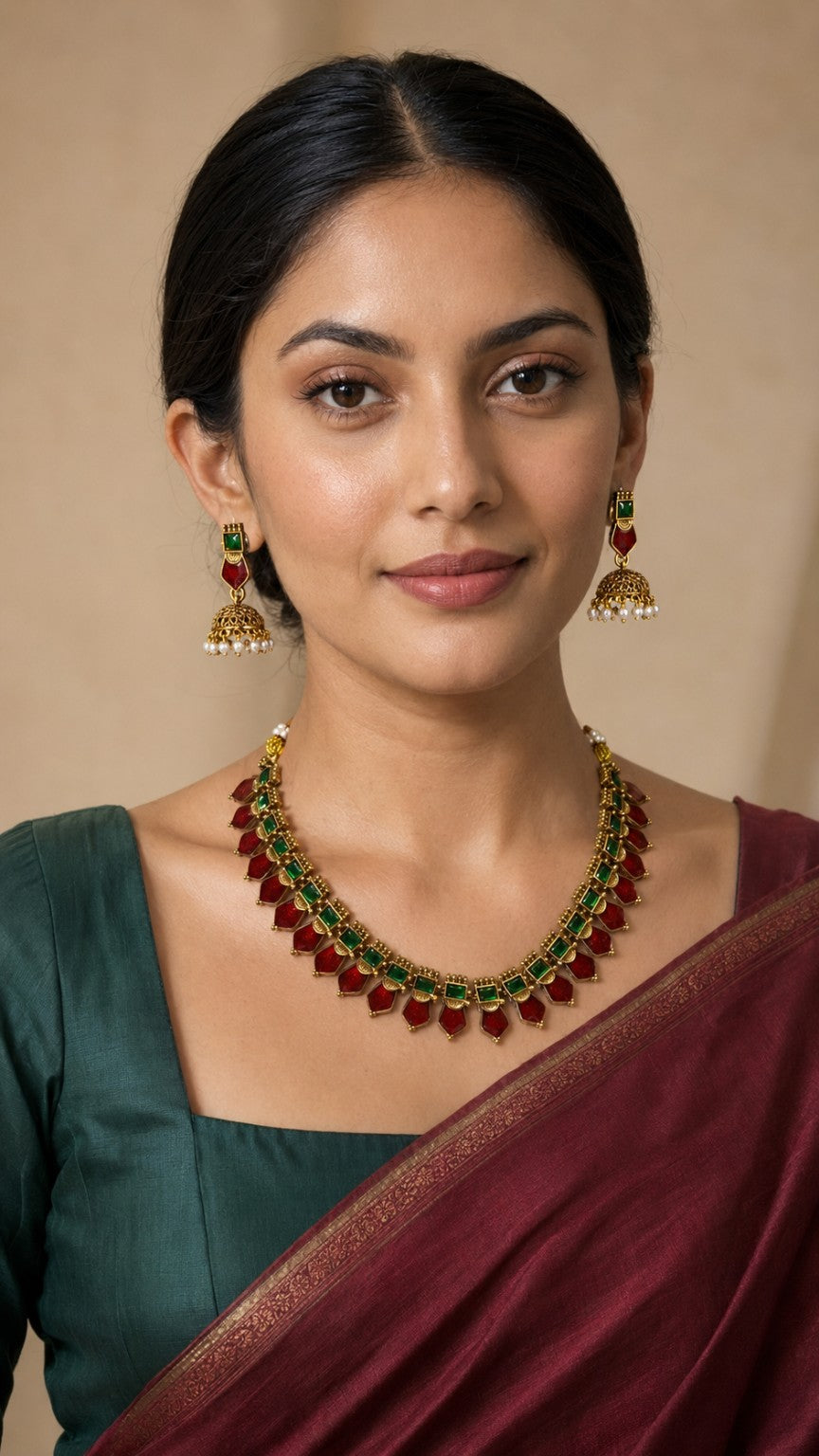 Traditional emerald drop stone necklace set by Belumiee with green ruby accents, featuring a detailed design and matching earrings.