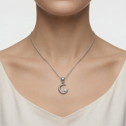 Silver-finish Moon & Star Pendant Necklace in 925 sterling silver, shown in a lifestyle view.