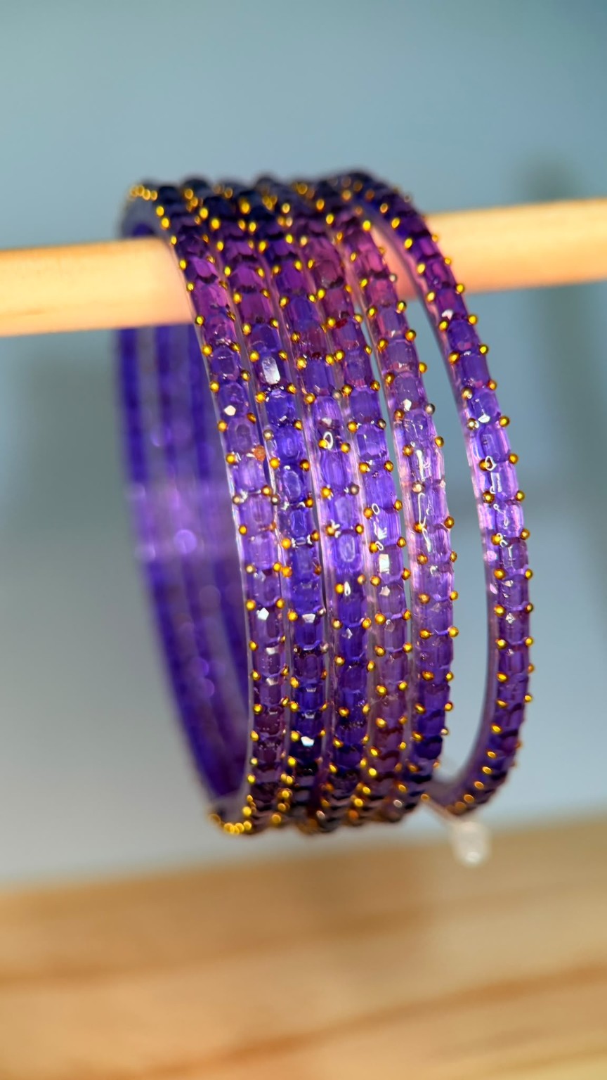 Lavender Navrang Sparkle Glass Bangles Set by Belumiee, featuring shimmering glass bangles with intricate design details.