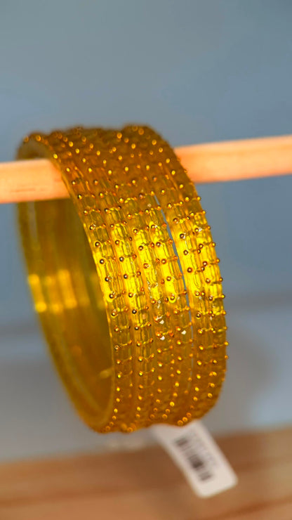 Lemon yellow Navrang Sparkle Glass Bangles Set by Belumiee showcasing shimmering glass bangles on a neutral background.