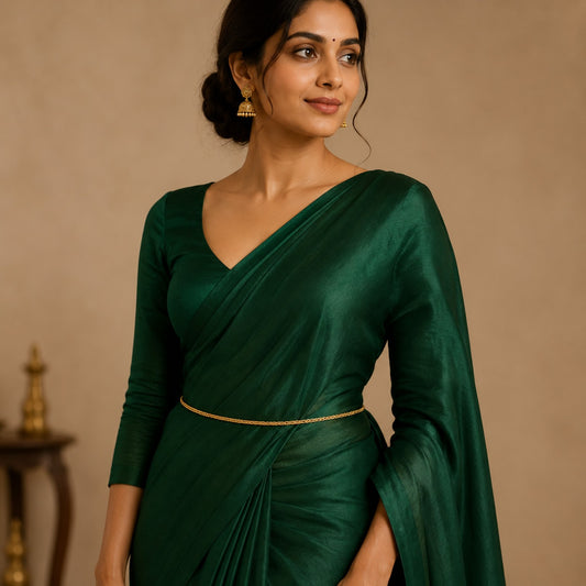 Model wearing a minimalist triple-strand gold-tone hip chain with a green saree