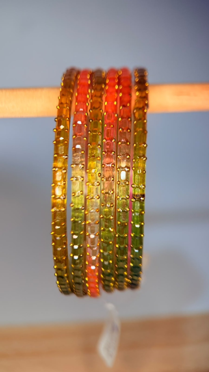Belumiee Navrang Sparkle Glass Bangles set with peach blossom design, featuring shimmering glass bangles for festive occasions.