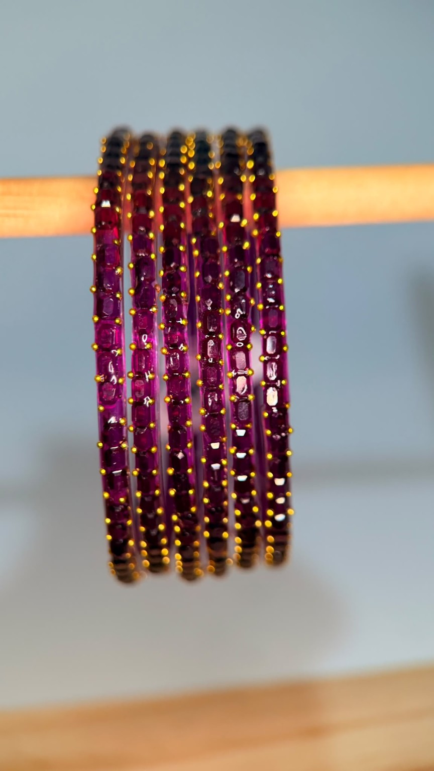 Belumiee Navrang Sparkle Glass Bangles Set with purple and plum-colored bangles featuring glittering designs.