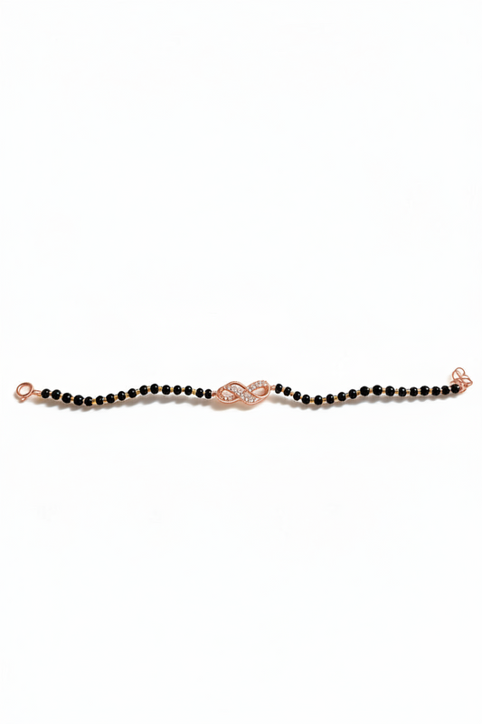 Sterling silver infinity charm bracelet with delicate chain and clasp, featuring a shiny infinity symbol charm.