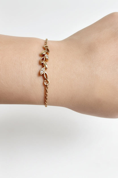 Gold-finish Dainty Leaf Bracelet in 925 sterling silver, shown in a lifestyle view.