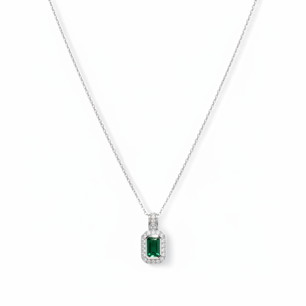 gold necklace with a green gemstone pendant on a white background