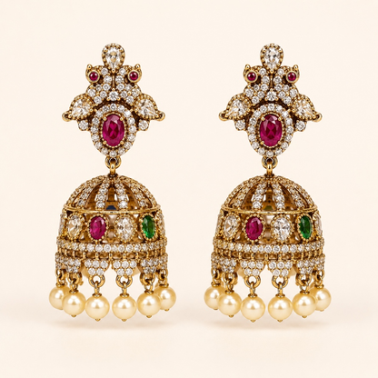 Gold-tone royal crystal dome jhumka earrings in Ruby and Emerald Green with pearl-style drops