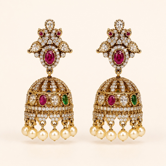 Gold-tone royal crystal dome jhumka earrings in Ruby and Emerald Green with pearl-style drops